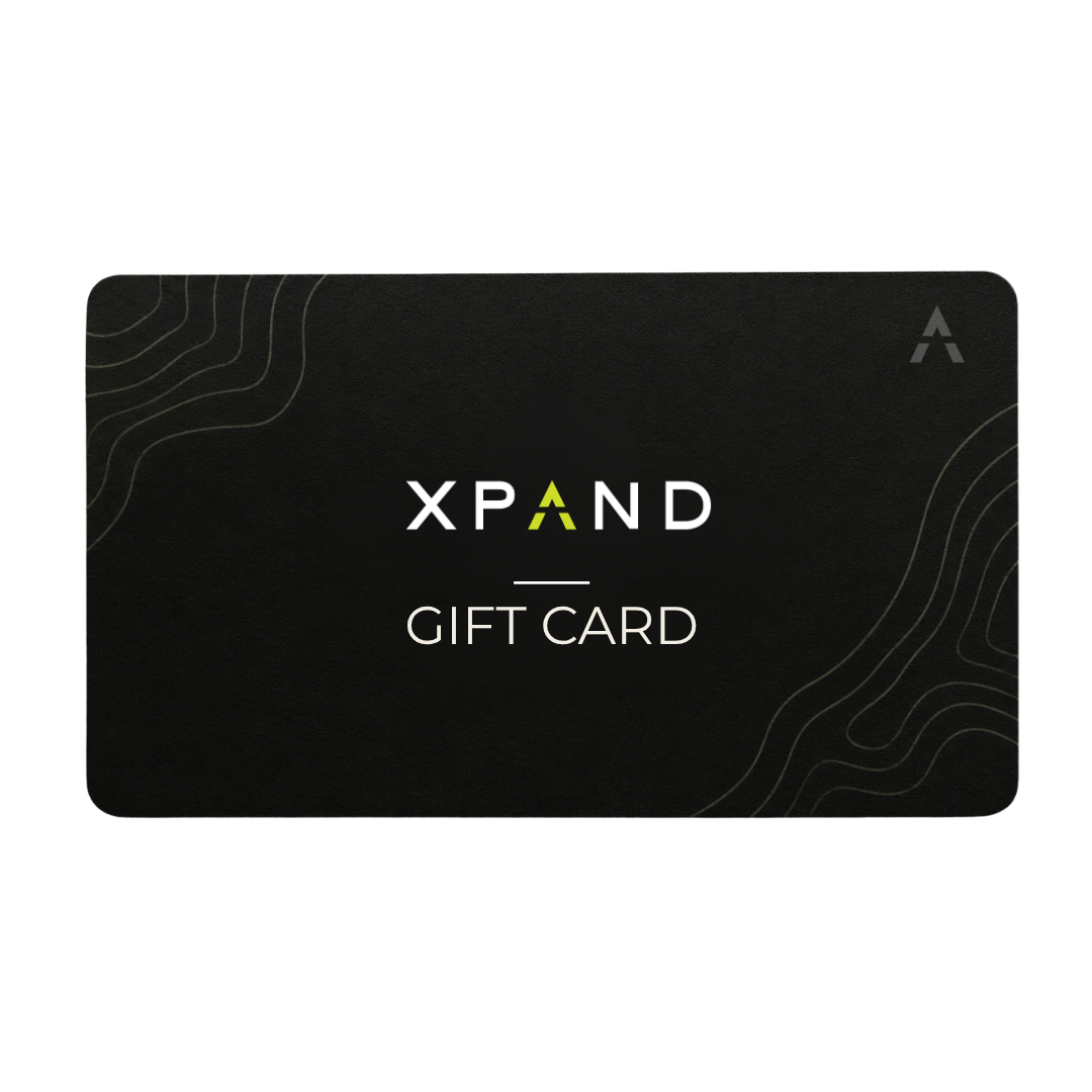 A black XPAND gift card with white text and a small green accent in the logo, shown on a plain white background.